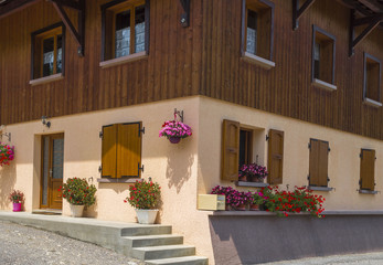 Fototapeta na wymiar Traditional French village house with flowers and windows.