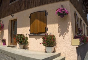 Traditional French village  house with flowers  and windows.