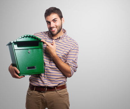 A handsome young man holding a malbox