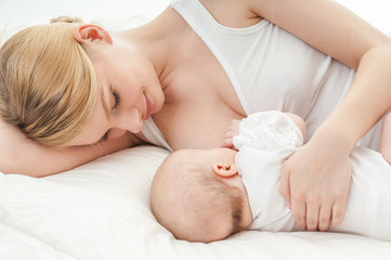 Obraz na płótnie Canvas Young mother breastfeeds her baby. Breast-feeding.