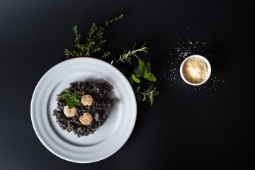 Black risotto with herbs and parmesan