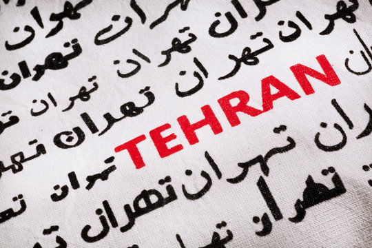 Selective focus on the word Tehran, in Farsi and English