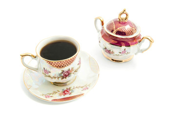 sugar bowl and cup of coffee