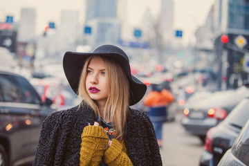 Fashionable young woman posing outside in a city street. Winter Fashion