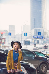 Fashionable young woman posing outside in a city street. Winter Fashion