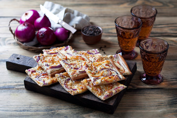 Tart flambee with onion, bacon and apples (Flammkuchen), selective focus