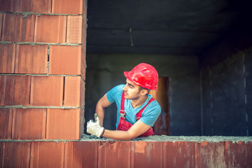 portrait of male construction engineer approving on quality control of new house. industrial construction site