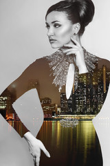 Composite image of a elegant young woman superimposed on an image of a city at night. Double exposure