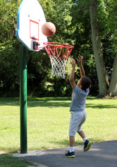 Young Boy Playing Basketball