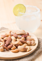 cashew and various nuts on wood dish