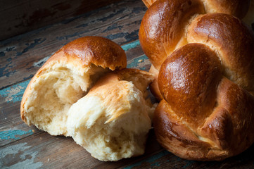 Freshly baked crusty bread served on a rustic wooden table.