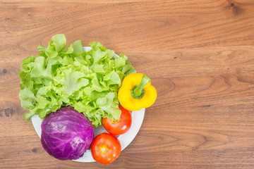 fresh vegetables in white dish on wood table