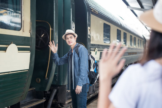 Handsome Young Asian man say goodbye to girlfriend at train stat
