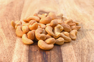 Salted cashew nuts on cutting board 