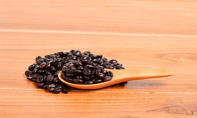 Coffee beans in wooden spoon