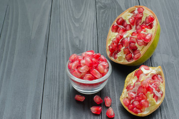 pomegranate in cup on wooden background