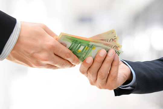 Businessman hands passing money, Euro currency (EUR)