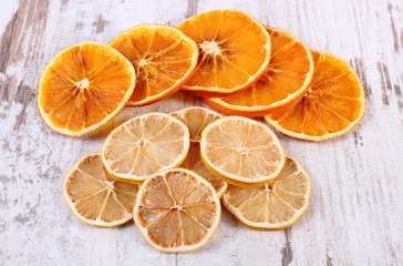 Fototapeta na wymiar Slices of dried lemon and orange on old wooden background