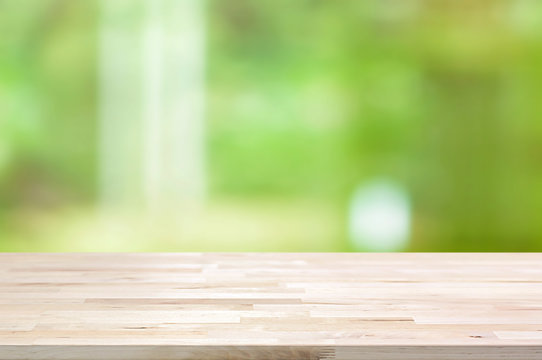 Wood table top on blur abstract green background