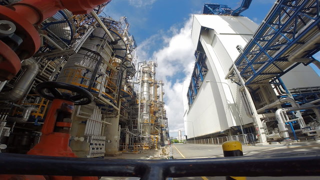 Time lapse of Refinery tower structure in process area of refinery plant with blue sky 