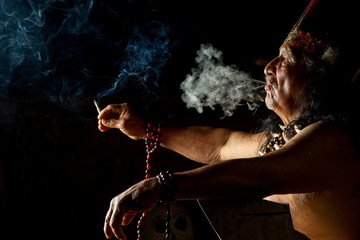 An old shaman from an indigenous tribe in the Amazon rainforest of Ecuador leads a ceremonial...