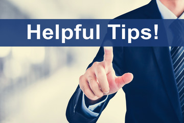 Businessman hand Helpful Tips! message on virtual screen