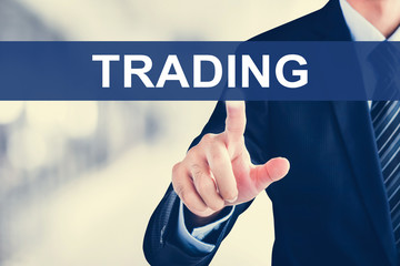 Businessman hand touching TRADING tab on virtual screen