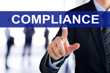 Businessman hand touching COMPLIANCE tab on virtual screen