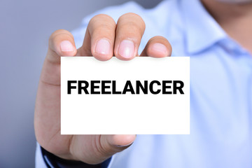 FREELANCER text on the card shown by a man