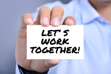 LET'S WORK TOGETHER! message on the card shown by a man