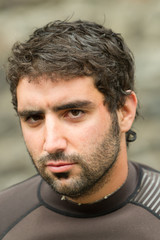 Obraz premium Adult man's face closeup wearing a neoprene wetsuit,perfect for water sports and diving enthusiasts seeking comfort and protection.