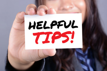 HELPFUL TIPS! message on the card shown by a businesswoman