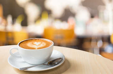 Selected focus empty brown wooden table and Coffee shop blur bac