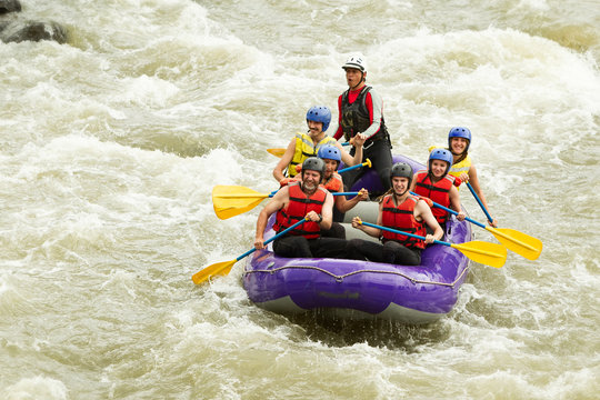 A family of seniors embarks on a thrilling white water rafting adventure in Ecuador with their experienced guide, navigating the powerful river as a team.
