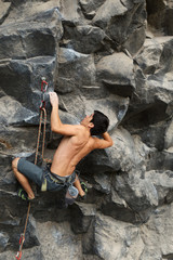 Capture the thrilling action of a rock climber scaling a wall from a dynamic and immersive perspective.