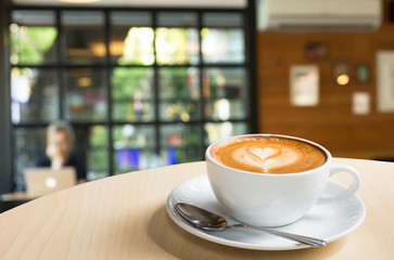 Selected focus empty brown wooden table and Coffee shop blur bac