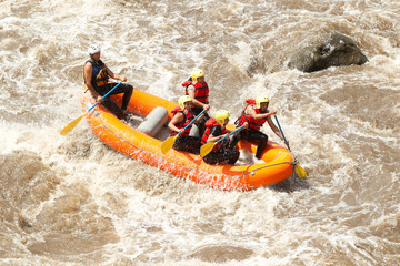 A fit woman navigating through thrilling whitewater rapids on a rafting adventure, filled with fun and excitement.
