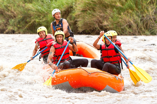 A group of friends in a white raft navigate the flowing waters, united in their love for rafting and adventure.