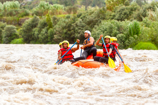 A diverse group of male and female tourists led by a skilled instructor embarking on an exhilarating whitewater river rafting excursion in Ecuador