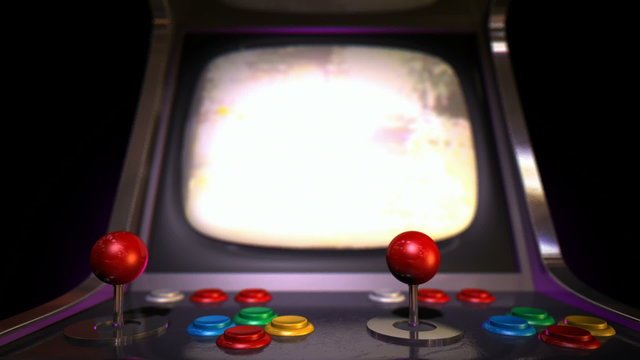 A pan across of a vintage arcade game with a joystick and a green screened monitor on an isolated white background
