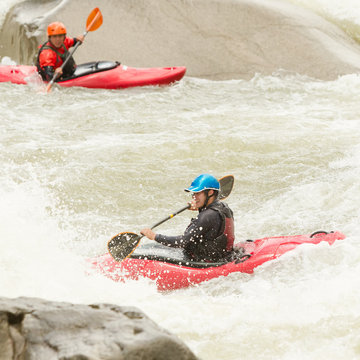 Experience the thrill of kayaking in the beautiful Pastaza River in Ecuador,where two kayaks dance through the rushing waters.