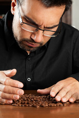 Expert coffee sommelier meticulously analyzing and evaluating the quality of freshly roasted coffee beans for an exceptional sensory experience.
