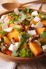 Healthy salad with persimmon, arugula and cheese macro vertical
