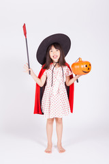 little girl in black hat  with halloween pumpkin