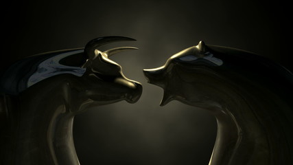 A closeup pan of two bronze castings depicting a stylized bull and a bear head in contrasting light representing a financial market trends on an isolated dark background