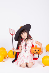 little girl in black hat  with halloween pumpkin
