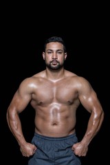 Obraz na płótnie Canvas Portrait of a bodybuilder man flexing muscles