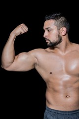 Fototapeta na wymiar Bodybuilder man flexing his muscles
