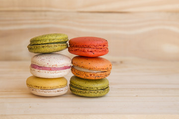 french colorful macarons on wooden floor