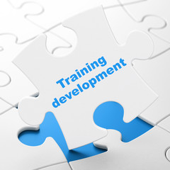 Education concept: Training Development on puzzle background